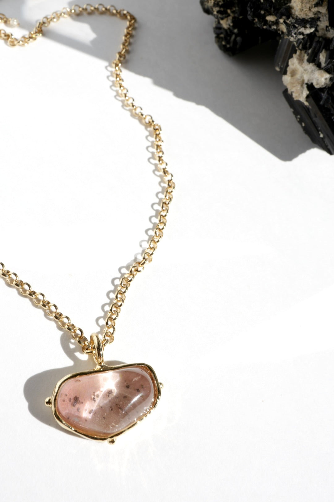 Quartz necklace with a pink stone pendant on a white background